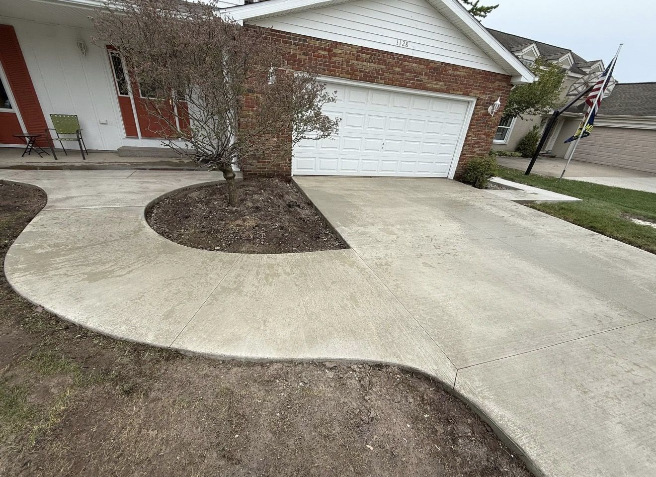 Custom curved concrete driveway with decorative cut